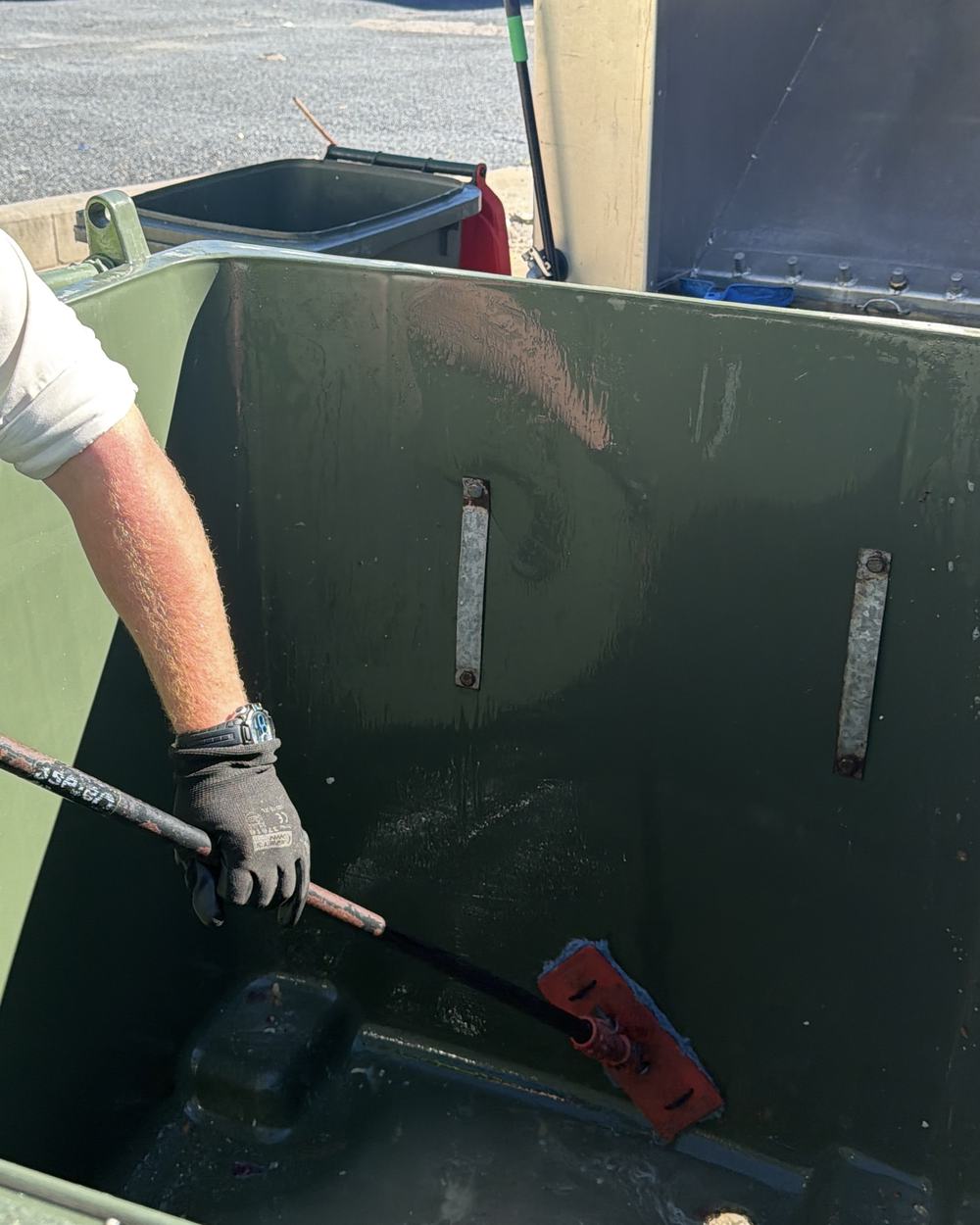 Scrubbing the inside of a commercial bin