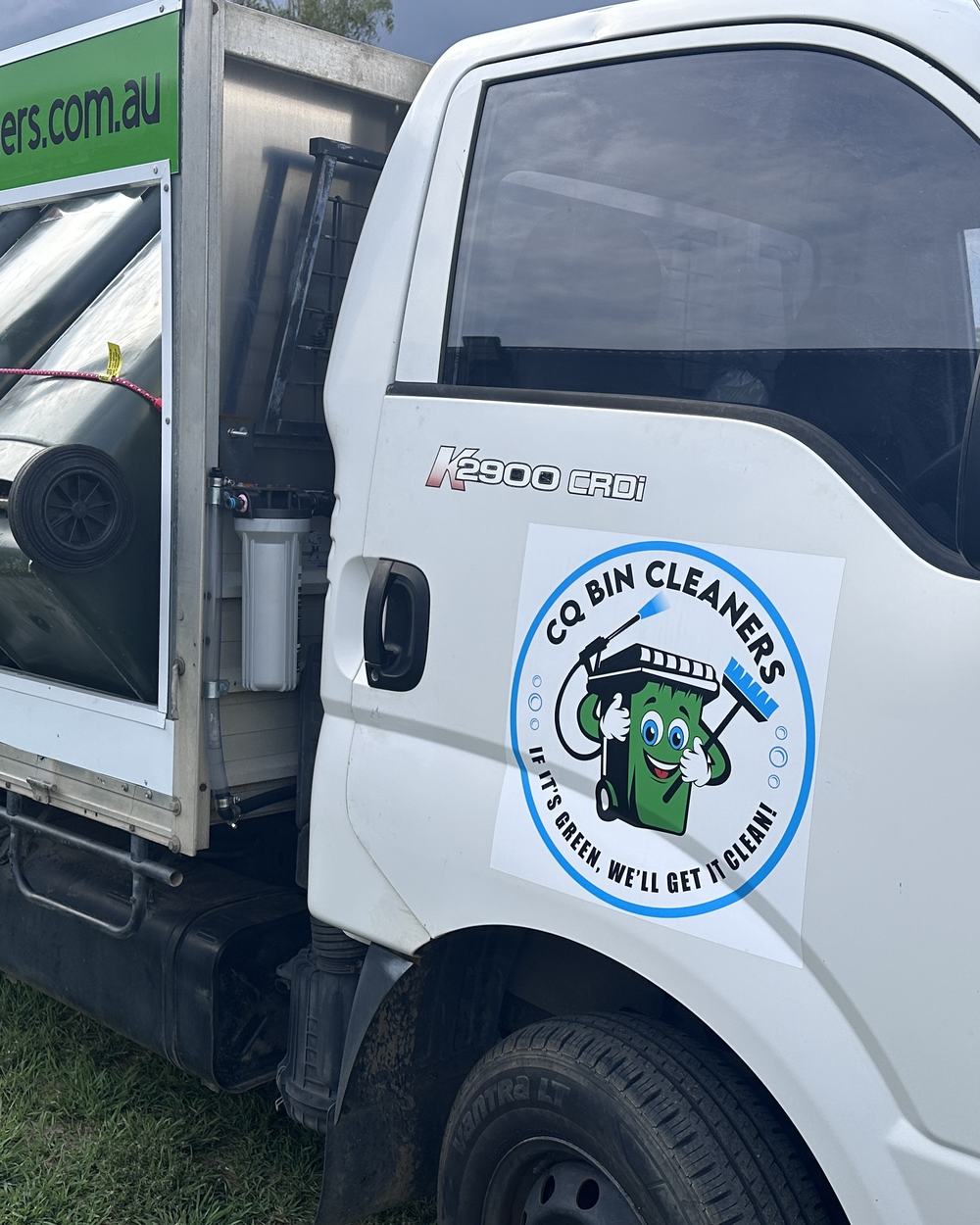 The CQ Bin Cleaners logo on the truck door